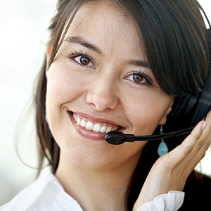 A smiling woman wearing a telephone headset