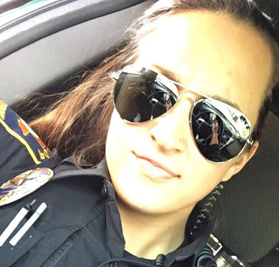 Officer Marisa Bogart smiling and wearing mirrored sunglasses