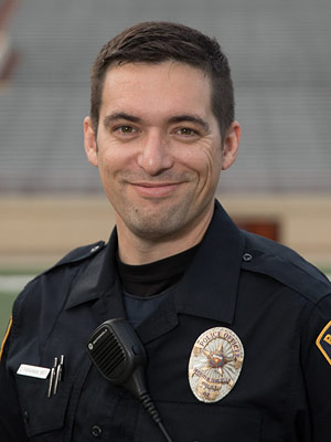 Officer Farahnak smiles in his police uniform