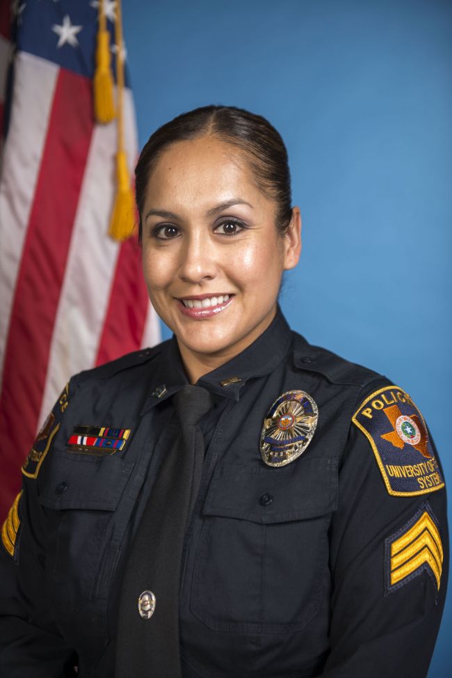 Officer Veronica Rangel in her police uniform in front of an American flag